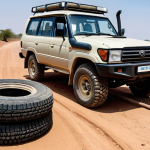 A male traveler, fully clothed in modest, practical safari attire, thoroughly inspecting the rugged tires and undercarriage of a powerful 4WD SUV (e.g., Toyota Land Cruiser) on a dusty, unpaved road in Burkina Faso. The vehicle is high-clearance and looks ready for challenging terrain. In the background, a vast, arid landscape under a clear sky. A spare tire is visible, along with essential off-road equipment like a tow rope and shovel nearby. safe for work, appropriate content, fully clothed, perfect anatomy, correct proportions, natural pose, professional photography, high quality, well-formed hands, natural body proportions, family-friendly.